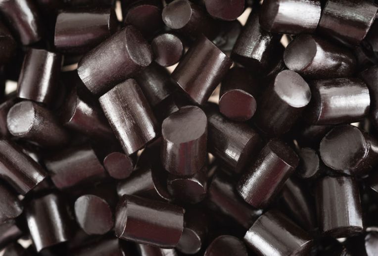 23305973 - black pieces liquorice candy  background